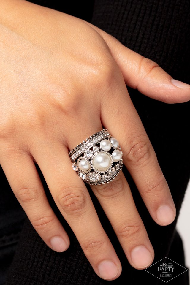 Chunky silver band adorned with iridescent pearls and radiant rhinestones in a haphazard sprinkle pattern. Features stretchy band for flexible fit. Sold as one individual pearl ring from