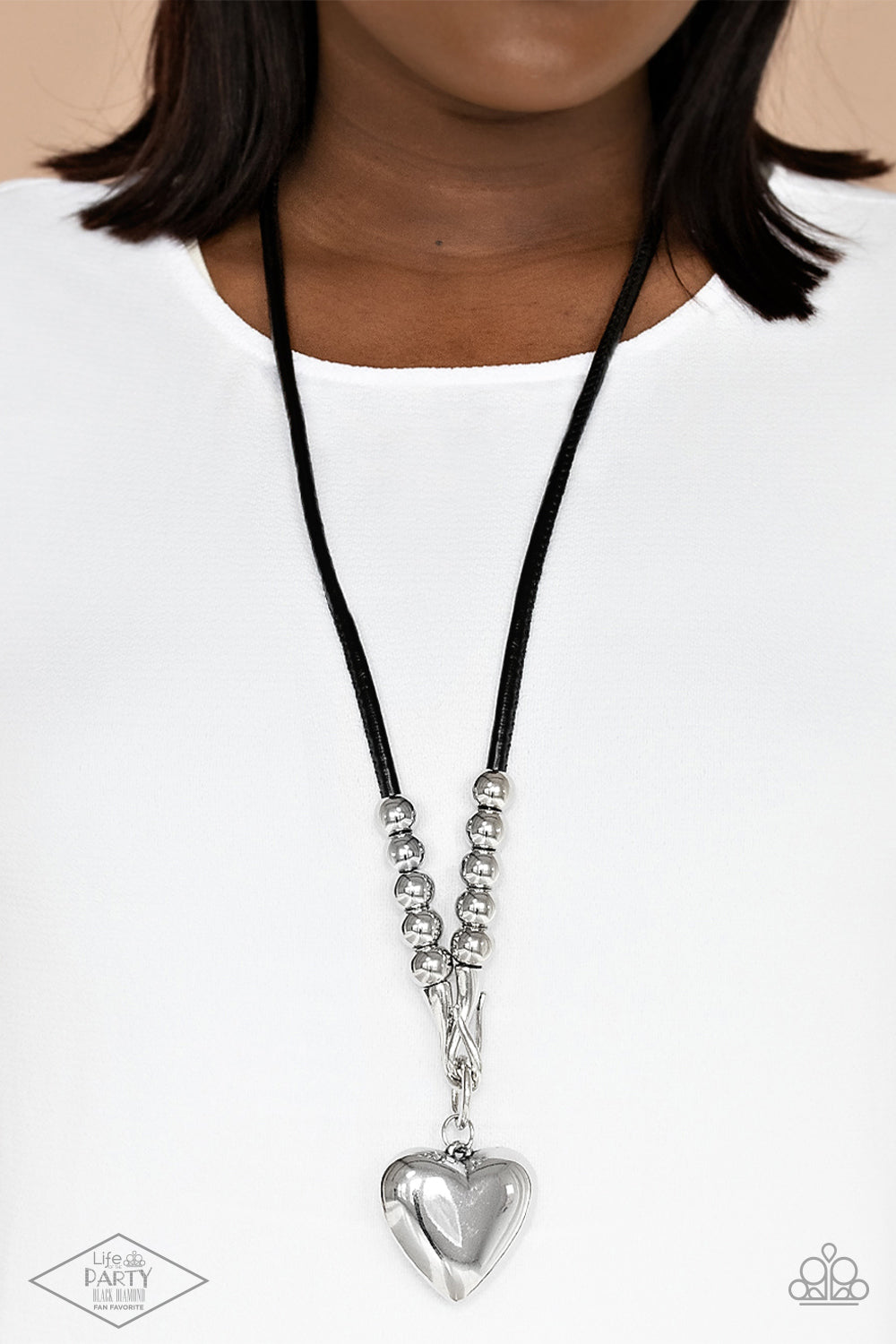Paparazzi Forbidden Love - Black Necklace - Black Pendant Necklace Chunky silver beads, a silver heart pendant swings from a silver hook-like fittings that attach to a bold leather cord across the chest for a heartbreaker look. Sold as one individual black pendant necklace.