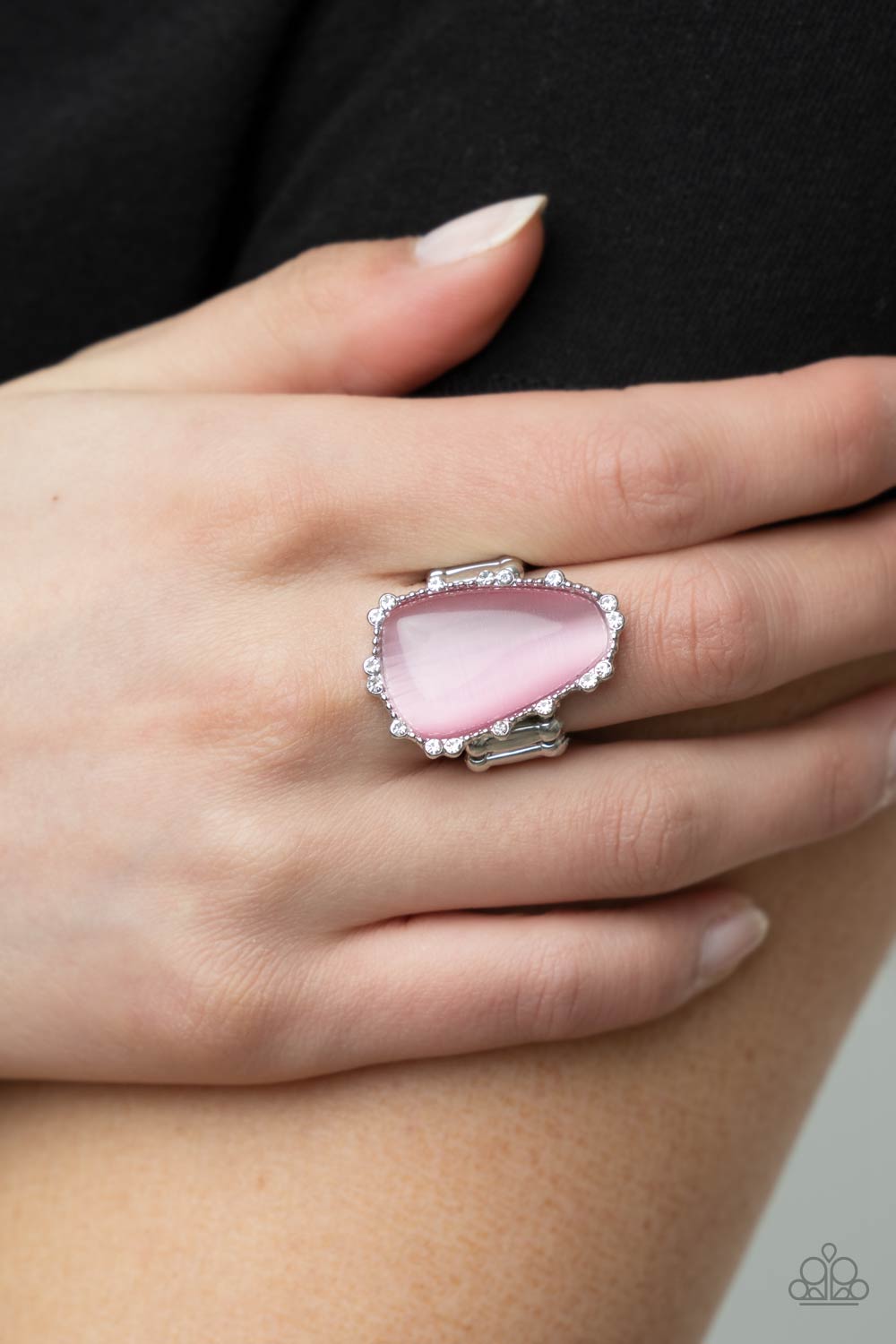 Paparazzi Jewelry Newport Nouveau - Pink Ring Pusher P A tranquil asymmetrical pink cat's eye stone is encased in a delicately dotted shimmery silver frame.Features a stretchy band for a flexible fit. Sold as one individual ring.