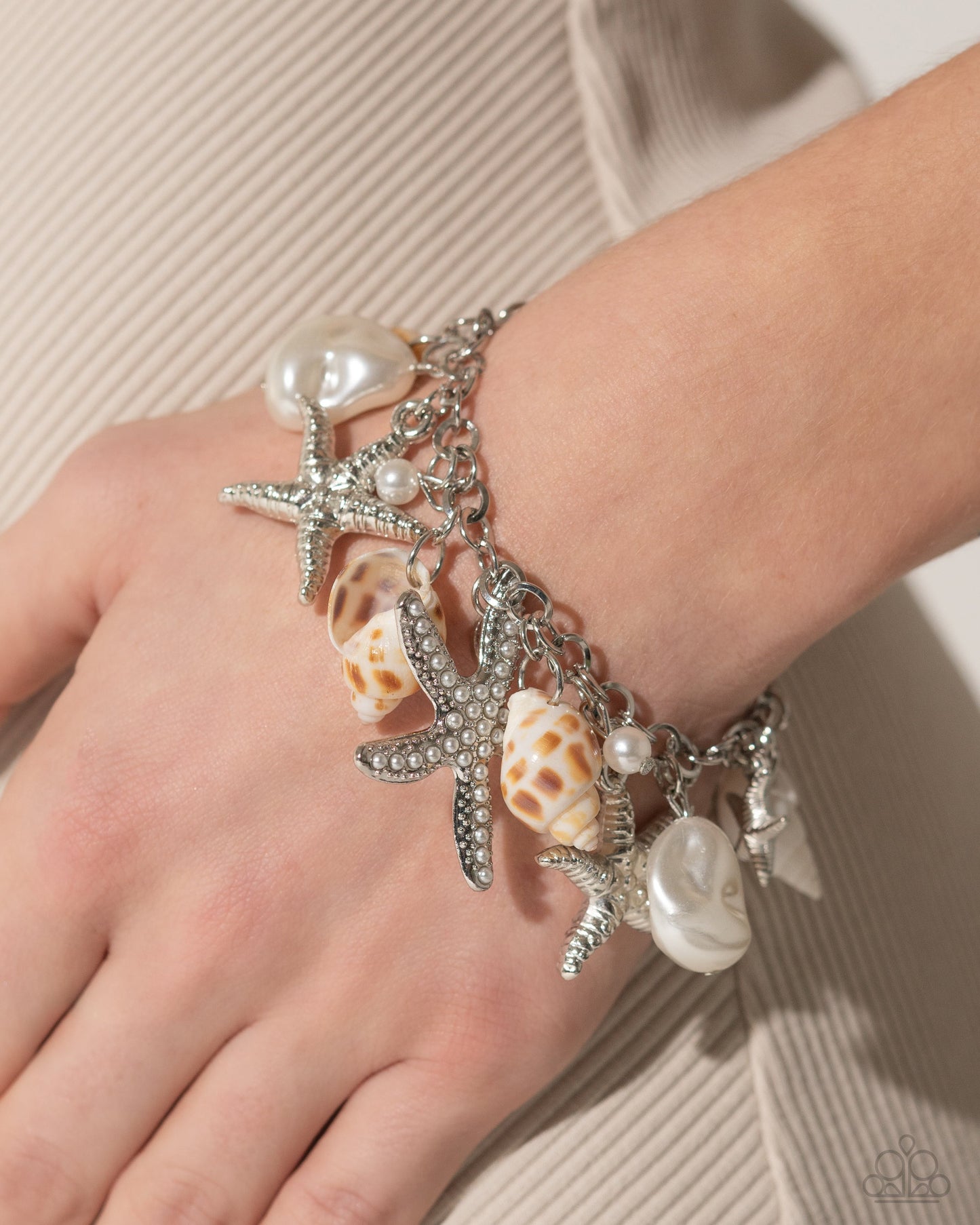 Paparazzi Seashell Song - White Charm Bracelet - A bracelet adorned with a mix of silver starfish, baroque pearls, and delicate seashells. Pusher P