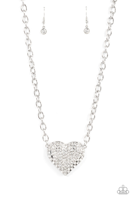 Heartbreakingly Blingy - White Necklace - Life Of The Party Paparazzi Exclusive A oversized silver heart is encrusted in rows of white rhinestones, resulting in heart-racing sparkle. Sold as one individual white necklace. Includes one pair of matching earrings. Free shipping on orders over $75
