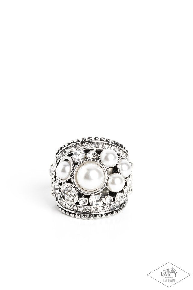 Chunky silver band adorned with iridescent pearls and radiant rhinestones in a haphazard sprinkle pattern. Features stretchy band for flexible fit. Sold as one individual pearl ring from
