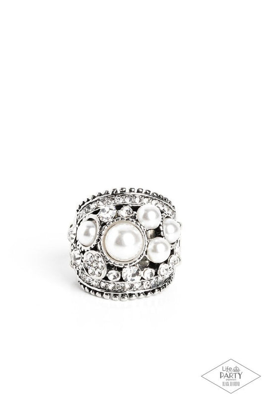 Chunky silver band adorned with iridescent pearls and radiant rhinestones in a haphazard sprinkle pattern. Features stretchy band for flexible fit. Sold as one individual pearl ring from
