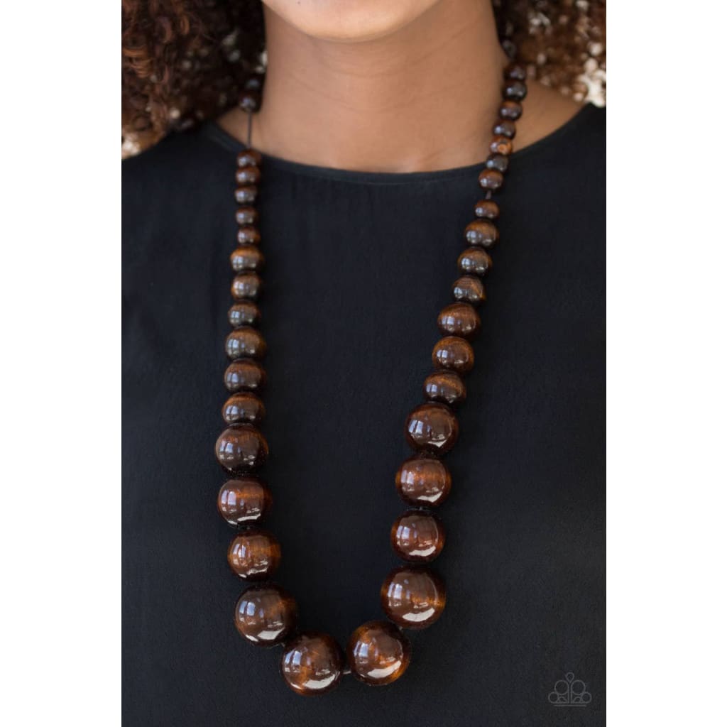 Paparazzi Effortlessly Everglades - Brown Necklace Gradually increasing in size near the center, earthy wooden beads are threaded along a brown string for a summery look. Features an adjustable sliding knot closure. Sold as one individual necklace. Includes one pair of matching earrings. Paparazzi Accessories are all Lead Free and Nickel Free