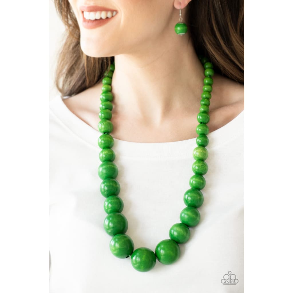 Paparazzi Effortlessly Everglades - Green Necklace Gradually increasing in size near the center, vivacious green wooden beads are threaded along a green string for a summery look. Features an adjustable sliding knot closure. Sold as one individual necklace. Includes one pair of matching earrings. Paparazzi Accessories are all Lead Free and Nickel Free. Paparazzi Effortlessly Everglades - Green Necklace